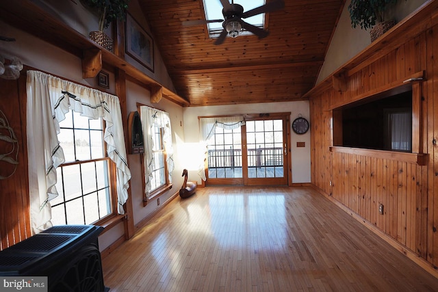 mudroom featuring hardwood / wood-style flooring, wood ceiling, a ceiling fan, and wood walls