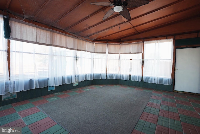 unfurnished sunroom with vaulted ceiling and ceiling fan