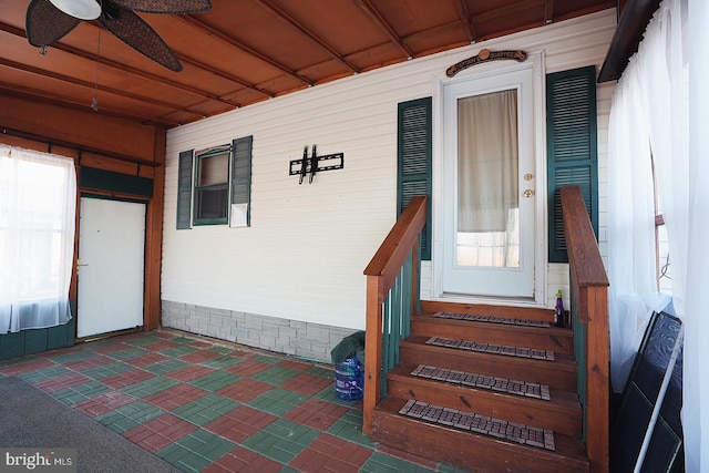 view of exterior entry featuring a ceiling fan