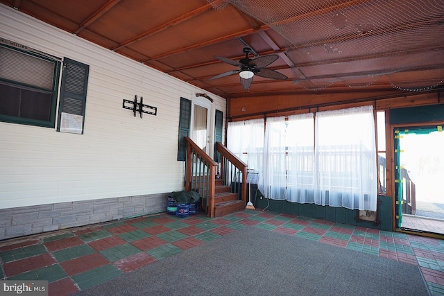 unfurnished sunroom with plenty of natural light and ceiling fan