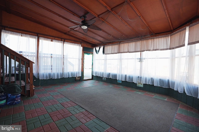 unfurnished sunroom featuring plenty of natural light, vaulted ceiling, and a ceiling fan