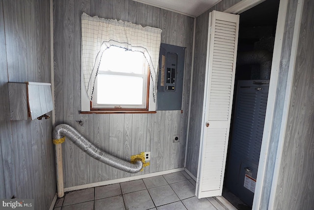 bathroom featuring wood walls, tile patterned flooring, and electric panel