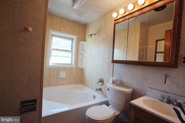 bathroom with decorative backsplash, toilet, bathtub / shower combination, vanity, and tile walls