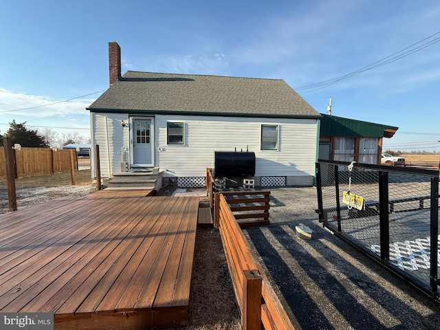 wooden deck with fence and area for grilling