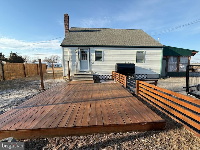 exterior space featuring entry steps, fence, and a grill