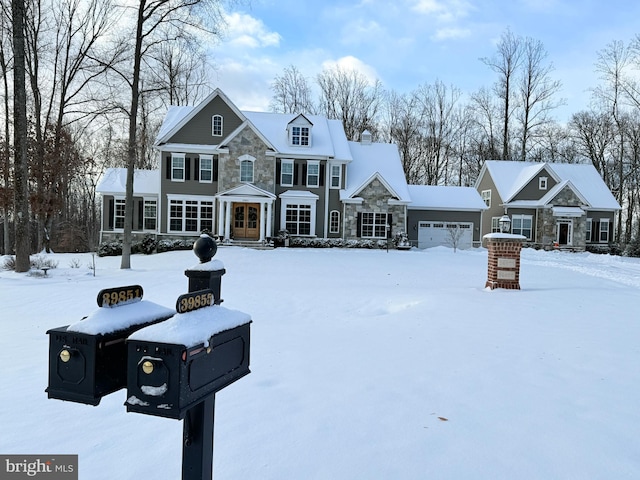 view of front of property featuring an attached garage and stone siding