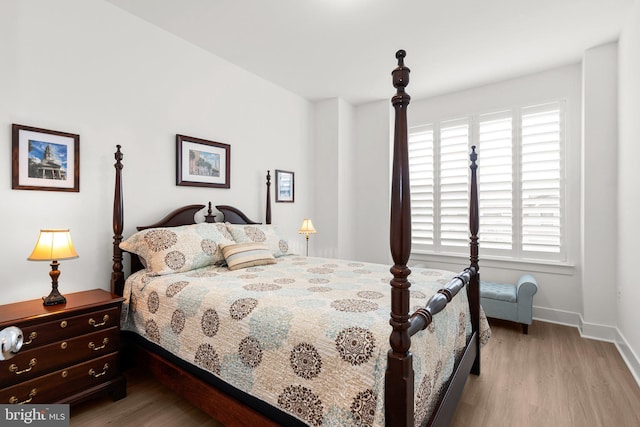 bedroom with wood finished floors and baseboards