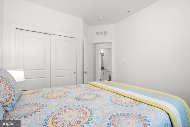 bedroom featuring visible vents and a closet