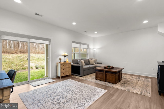 living room featuring plenty of natural light, recessed lighting, and light wood-style floors