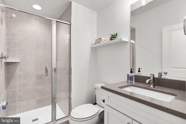 full bath featuring a stall shower, toilet, and vanity