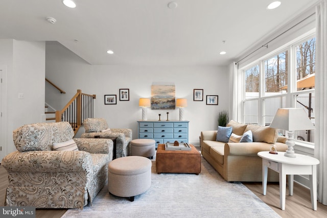 living area with stairs, recessed lighting, and wood finished floors