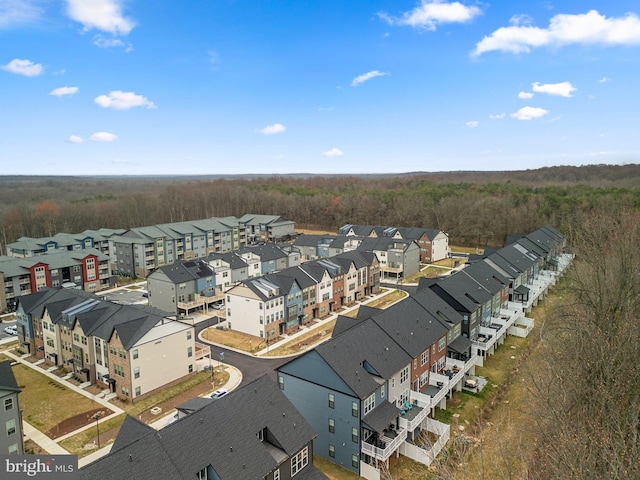 drone / aerial view featuring a forest view and a residential view