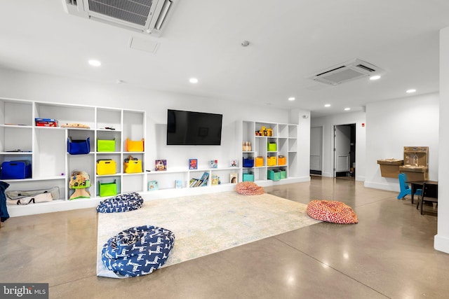 recreation room featuring visible vents, built in features, recessed lighting, concrete floors, and baseboards