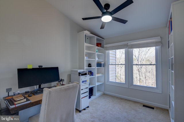 office featuring light carpet, baseboards, visible vents, and a ceiling fan