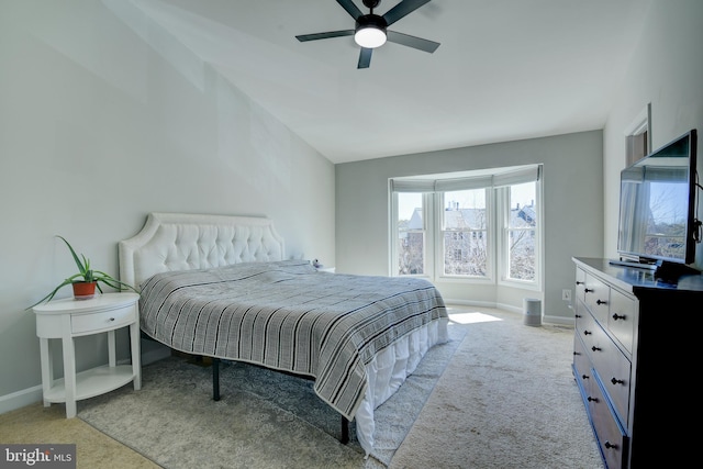 carpeted bedroom with ceiling fan and baseboards