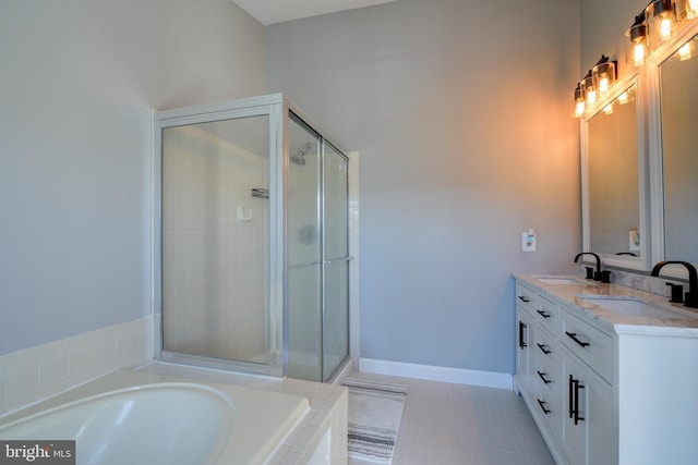 full bathroom featuring a bath, a stall shower, baseboards, and a sink