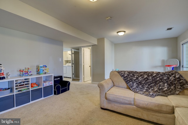 carpeted living area featuring washer and clothes dryer and visible vents