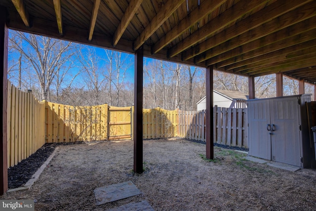 view of yard featuring a fenced backyard, a shed, and an outdoor structure