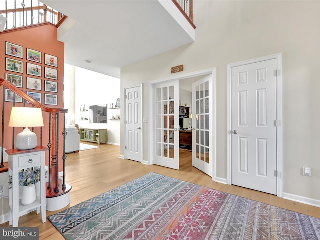 interior space with french doors, wood finished floors, and baseboards