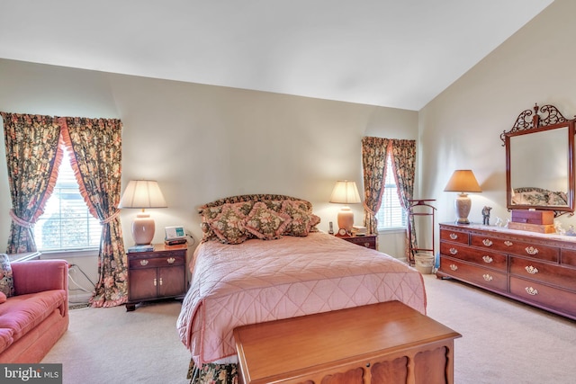 carpeted bedroom with lofted ceiling