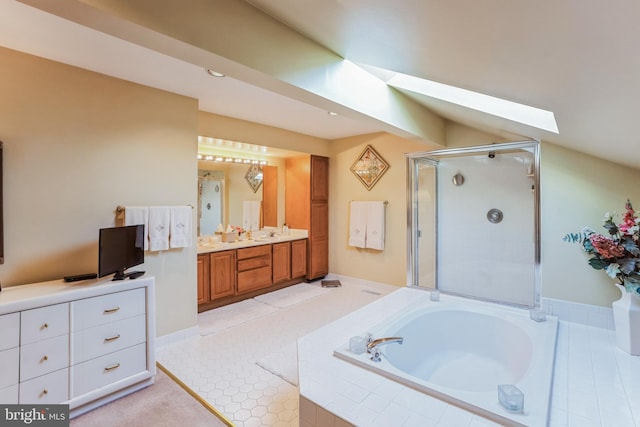 bathroom featuring a garden tub, lofted ceiling with skylight, a shower stall, vanity, and tile patterned floors