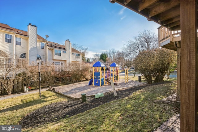 communal playground featuring a lawn