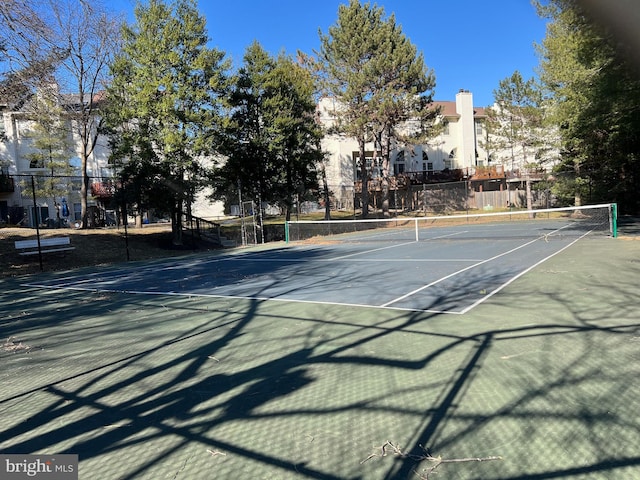 view of tennis court featuring fence