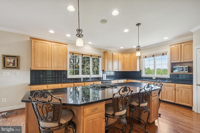 kitchen featuring dark countertops, stainless steel appliances, and a center island