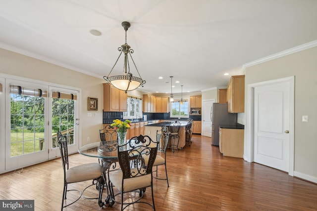 dining room featuring ornamental molding, recessed lighting, dark wood-style flooring, and baseboards