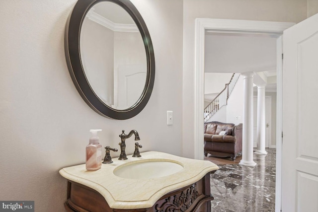 bathroom with decorative columns and vanity