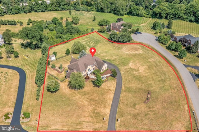 birds eye view of property with a rural view