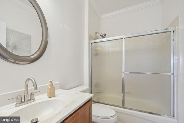 bathroom with ornamental molding, shower / bath combination with glass door, vanity, and toilet