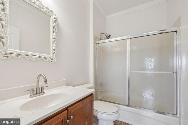 bathroom with enclosed tub / shower combo, ornamental molding, toilet, and vanity