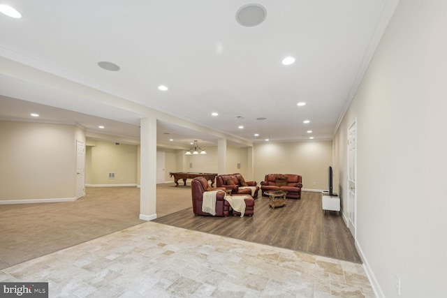 living area with baseboards, ornamental molding, and recessed lighting