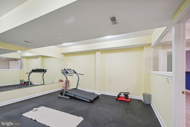 exercise room featuring visible vents and baseboards