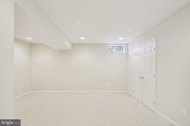 below grade area featuring baseboards, carpet flooring, and recessed lighting