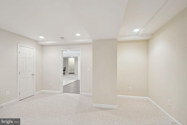 below grade area featuring baseboards, light colored carpet, and recessed lighting