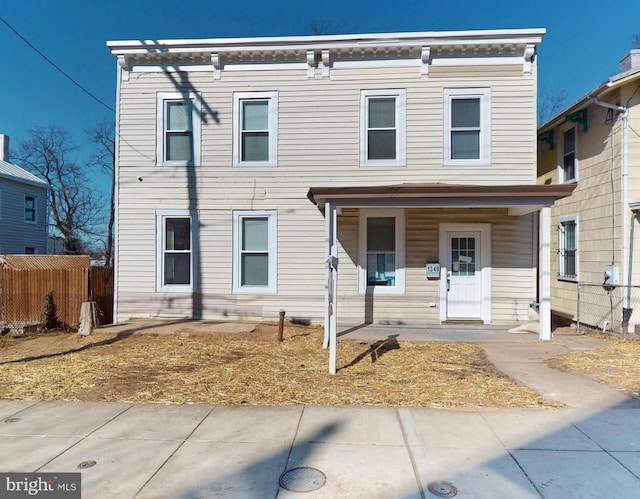 view of front of property with covered porch and fence