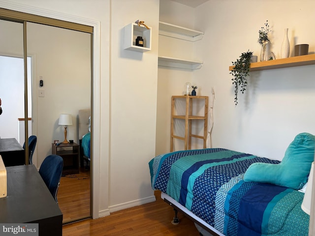 bedroom featuring dark wood-style floors and a closet