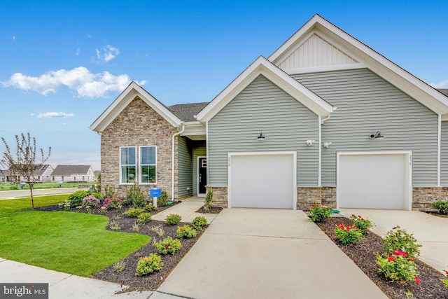 view of front facade featuring concrete driveway, stone siding, an attached garage, a front lawn, and board and batten siding