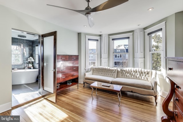 interior space with recessed lighting, ceiling fan, a wealth of natural light, and wood finished floors