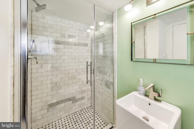 full bathroom featuring a sink and a shower stall