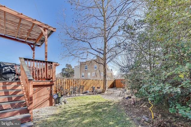 view of yard with stairs and fence