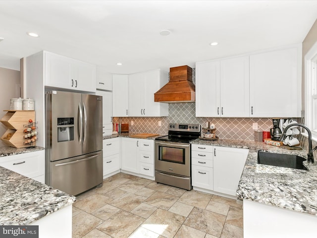 kitchen with a sink, stainless steel appliances, custom exhaust hood, and decorative backsplash