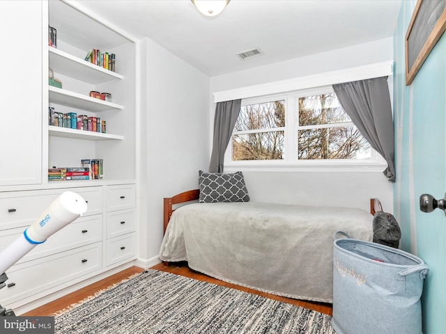 bedroom with wood finished floors and visible vents