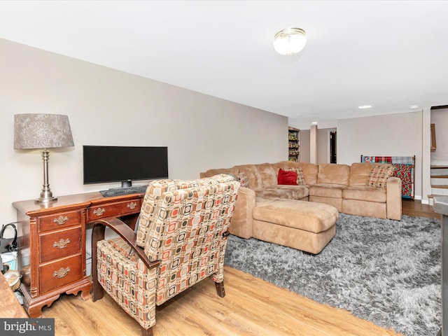 living area with stairs and wood finished floors