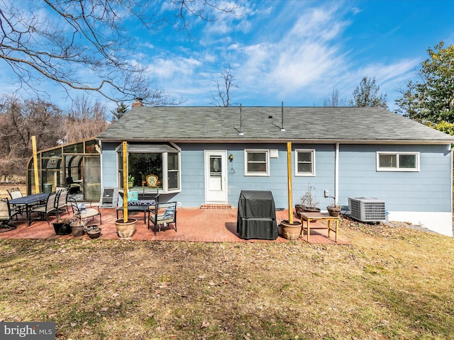 rear view of house featuring central AC, a chimney, and a patio area