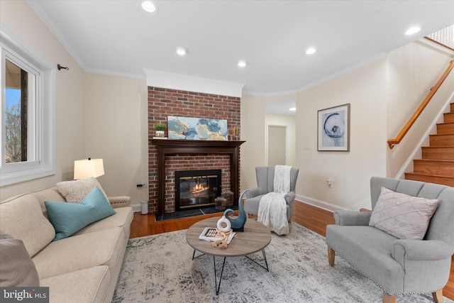 living room with stairs, crown molding, and wood finished floors