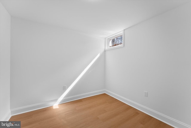 basement featuring light wood-style floors and baseboards