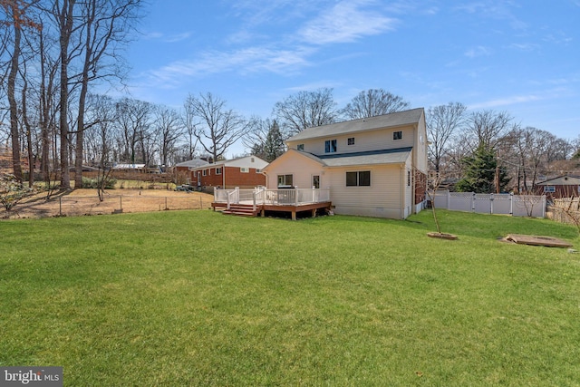 back of house featuring crawl space, fence, a wooden deck, and a lawn